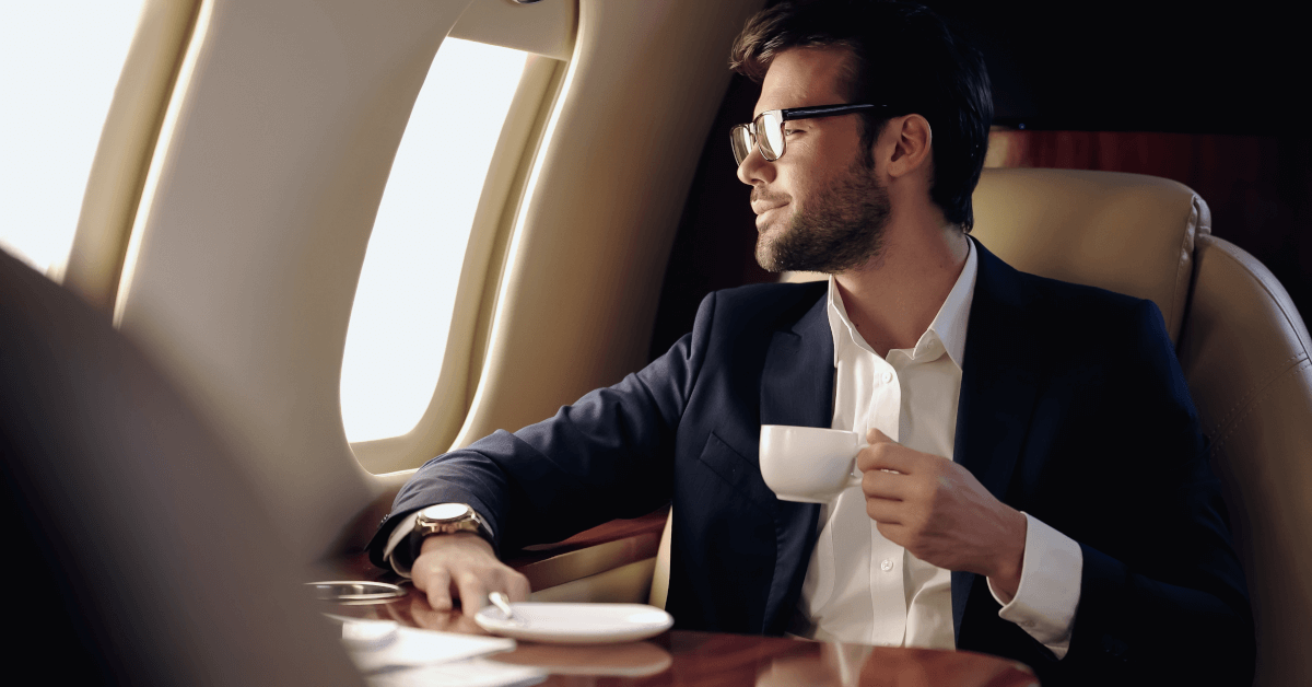 A man in a first-class seat on an airplane.