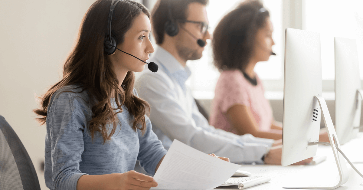 Three agents working at a call center.