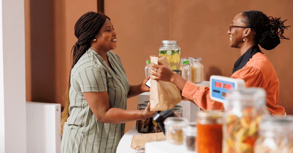 A woman providing customer service to a buyer.