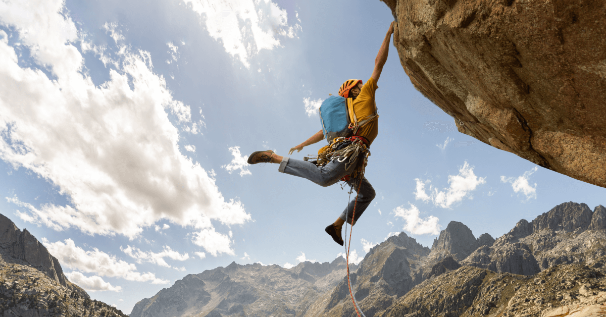 A man struggling to climb a mountain.