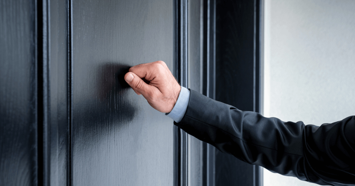 A man knocking on a door.