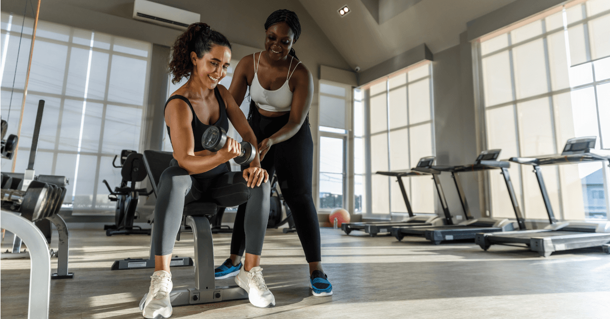 Two women working out in a gym.