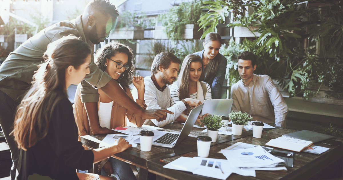 A group of people collaborating around a table on a project.