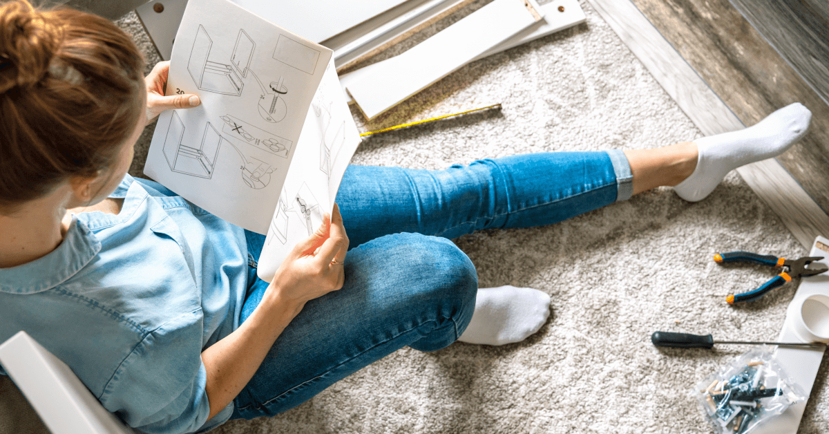 A woman reading an instruction manual.