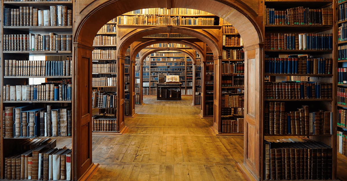 An archway in a library full of books.