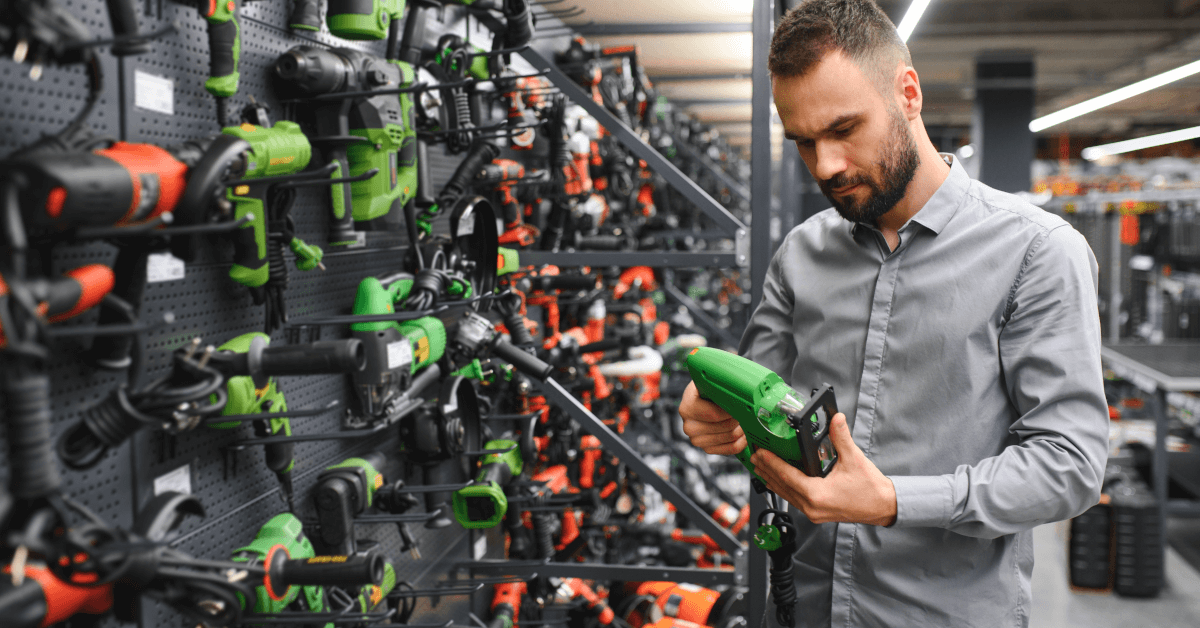 A man looking at tools in a hardware store.