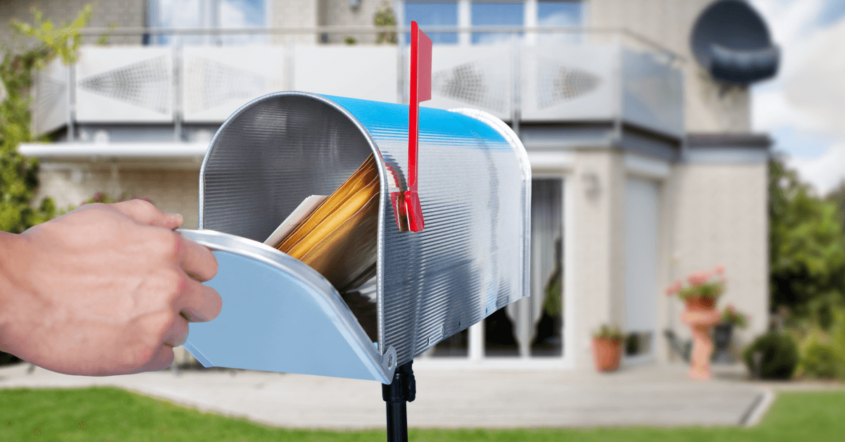 A full mailbox outside a suburban home.