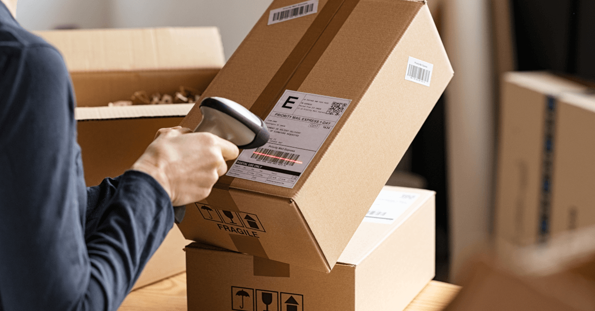 A man scanning some returned packages.